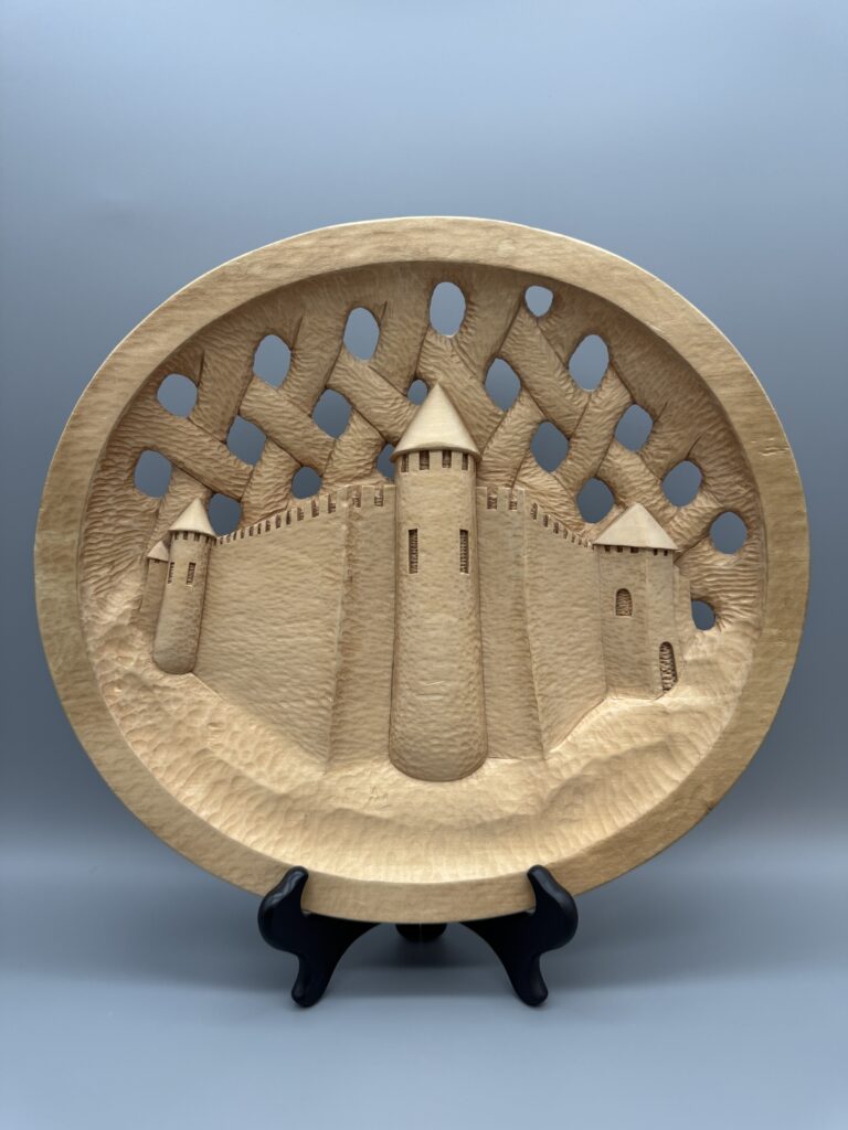 Decorative Wooden Plate featuring a carved castle design